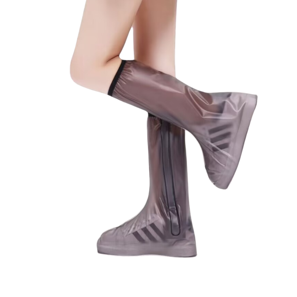 Clear rain boot covers over shoes on a white background